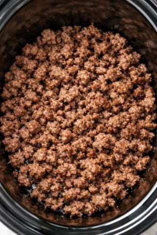 Throw browned ground beef in the slow cooker and 5 canned ingredients, and get a soup so delicious your husband will eat three bowls.